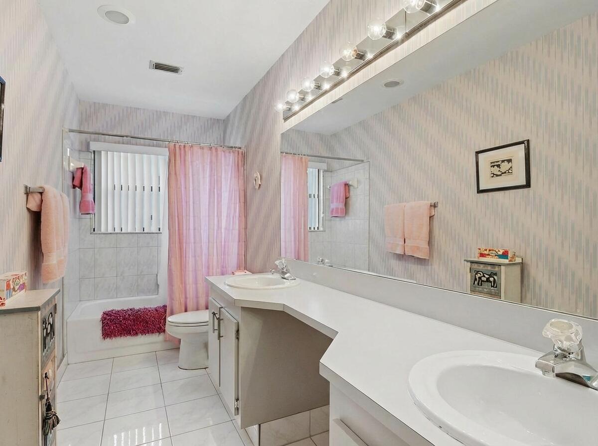9476 El Clair Ranch Road Boynton Beach, FL 33437 - Photo 19 of 28 a bathroom with a sink a vanity and a mirror