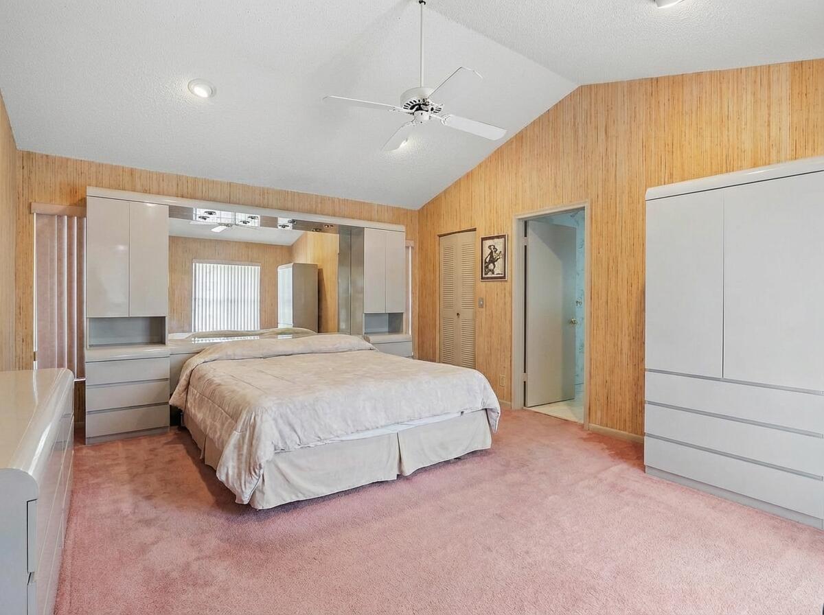 9476 El Clair Ranch Road Boynton Beach, FL 33437 - Photo 20 of 28 a spacious bedroom with a bed and a dresser