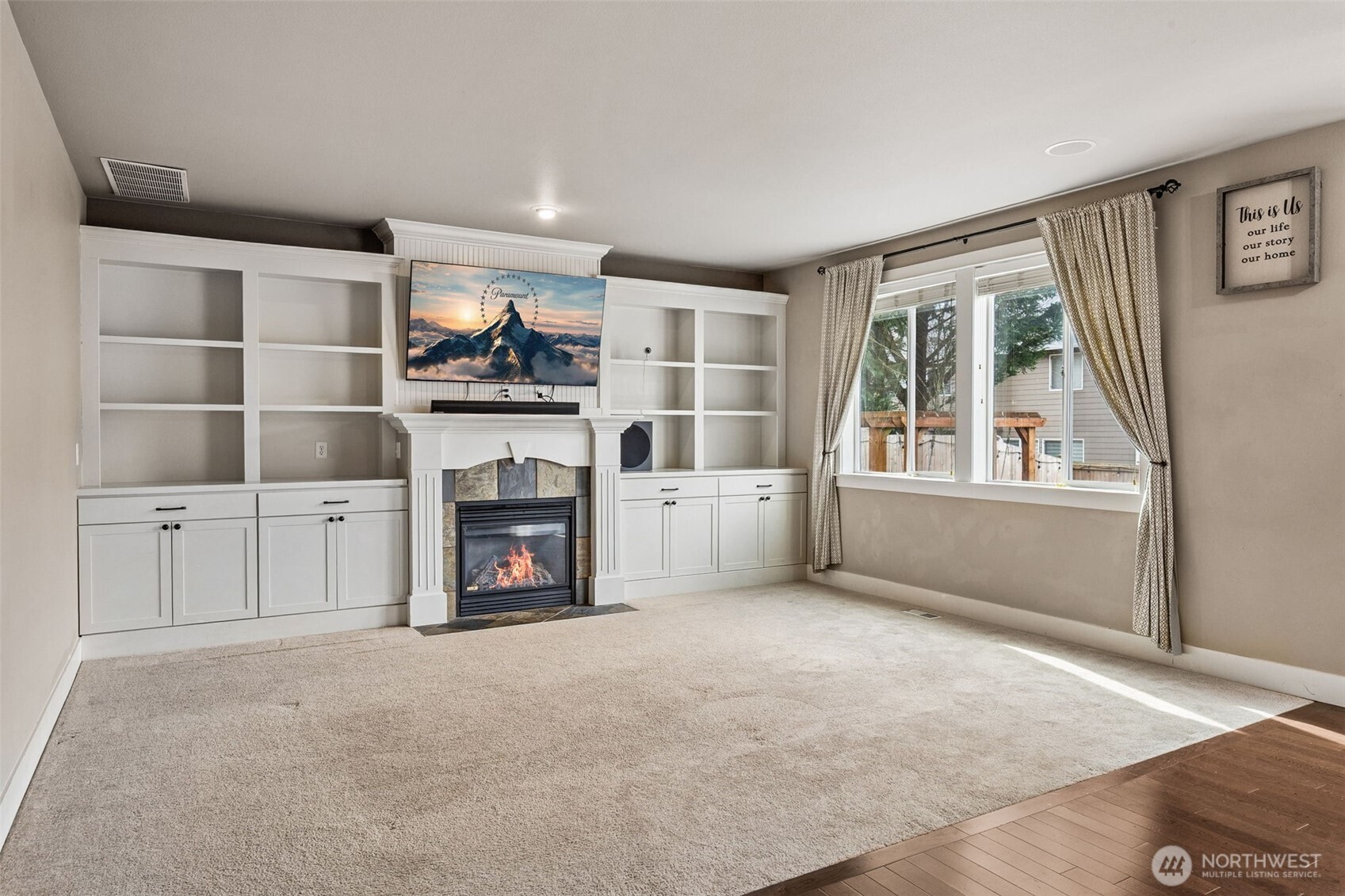 20522 95th Ave Court East Graham, WA 98338 - Photo 12 of 29 a living room with furniture a fireplace and a flat screen tv