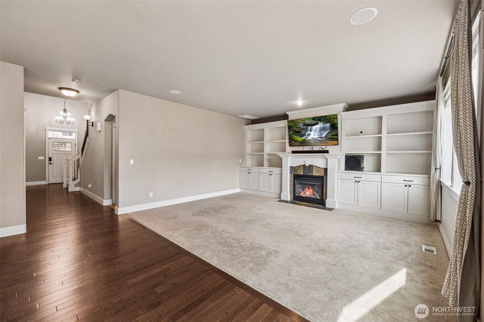 20522 95th Ave Court East Graham, WA 98338 - Photo 14 of 29 a view of a livingroom with wooden floor and a fireplace