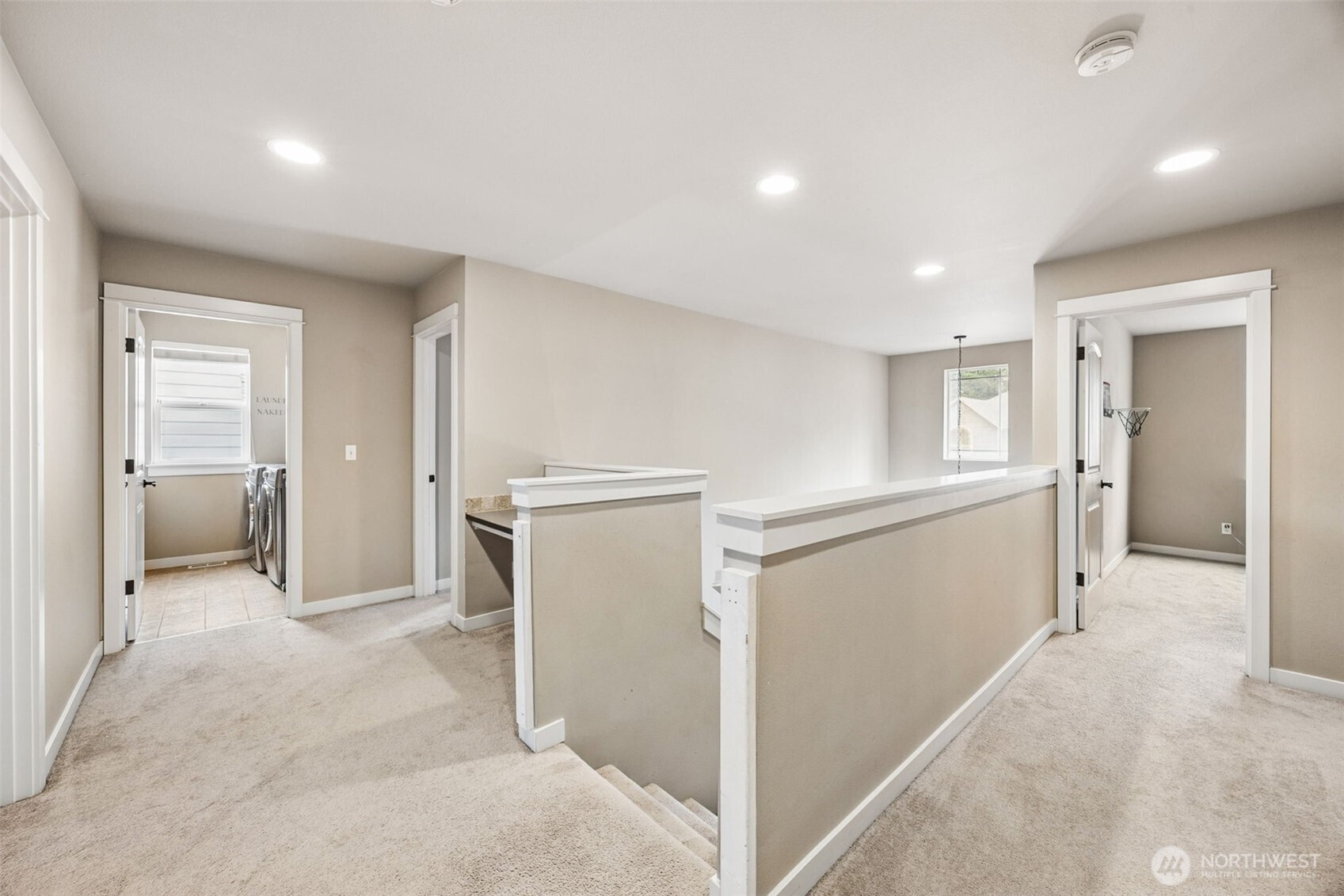 20522 95th Ave Court East Graham, WA 98338 - Photo 16 of 29 a view of a hallway with furniture and a refrigerator