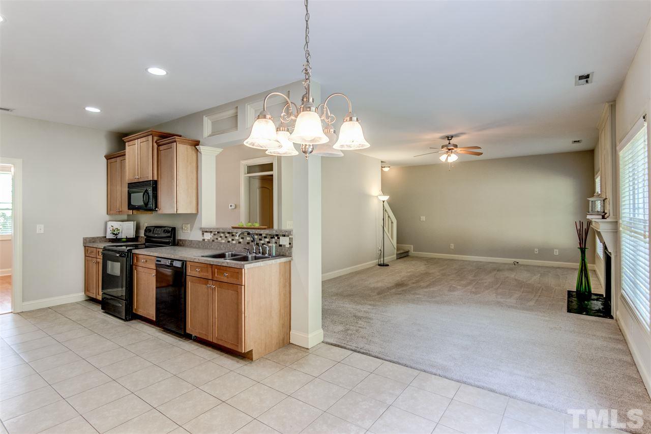 4143 White Kestrel Drive Raleigh, NC 27616 - Photo 12 of 30 a kitchen with stainless steel appliances granite countertop a sink and a refrigerator