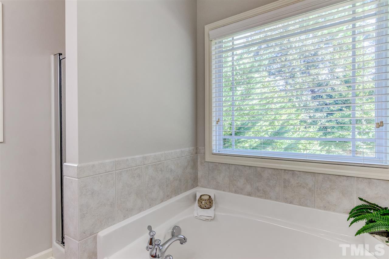 4143 White Kestrel Drive Raleigh, NC 27616 - Photo 17 of 30 a bathroom with a bathtub and a shower