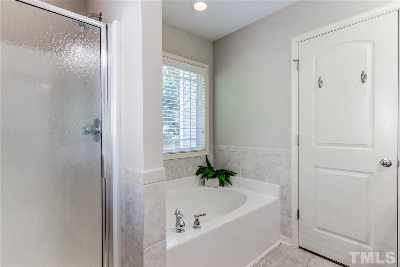 4143 White Kestrel Drive Raleigh, NC 27616 - Photo 18 of 30 a bathroom with a bathtub and a shower