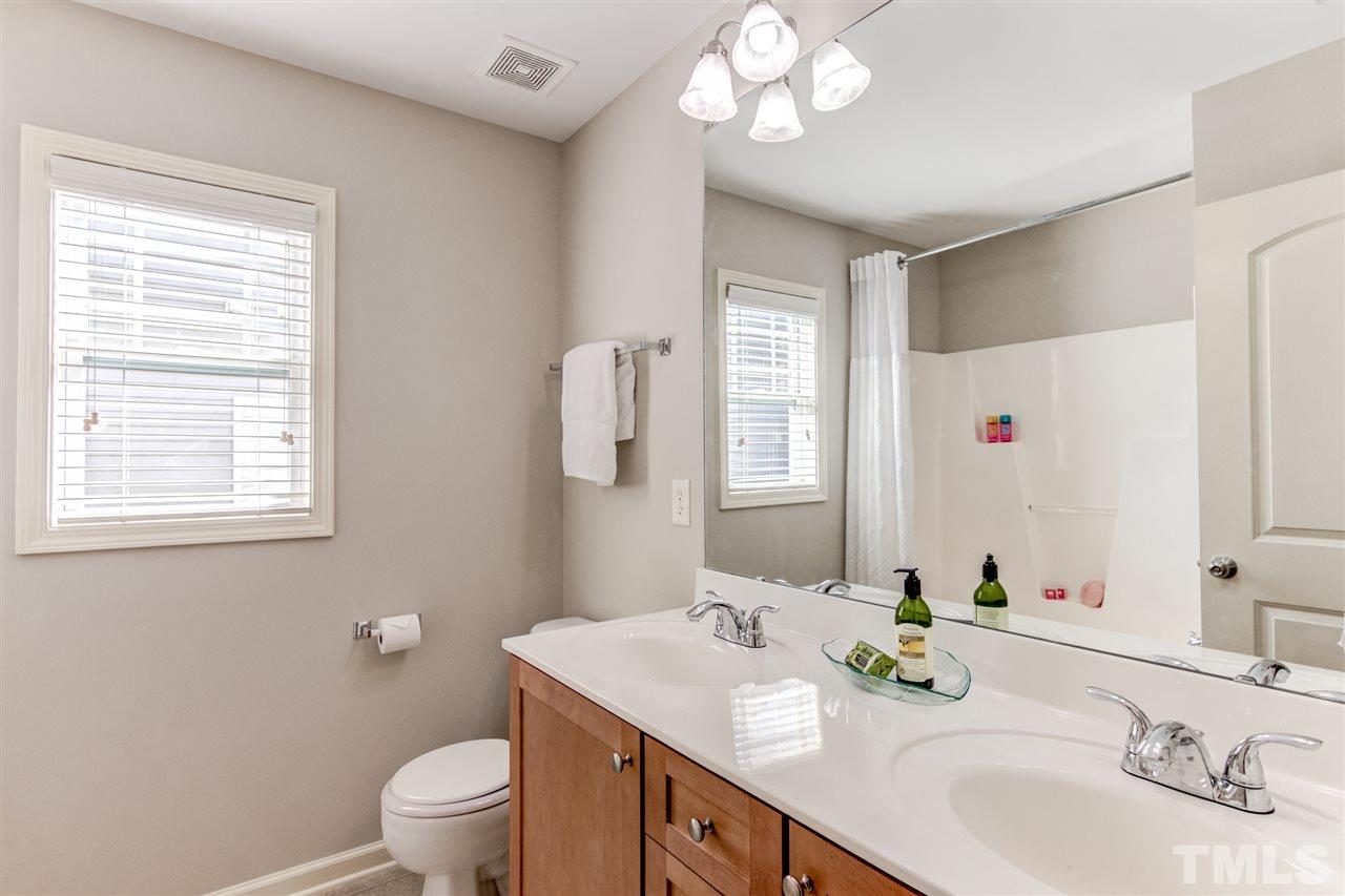 4143 White Kestrel Drive Raleigh, NC 27616 - Photo 20 of 30 a bathroom with a sink a toilet and a mirror