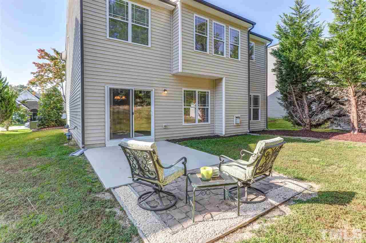 4143 White Kestrel Drive Raleigh, NC 27616 - Photo 24 of 30 a view of a chair and table in backyard of the house