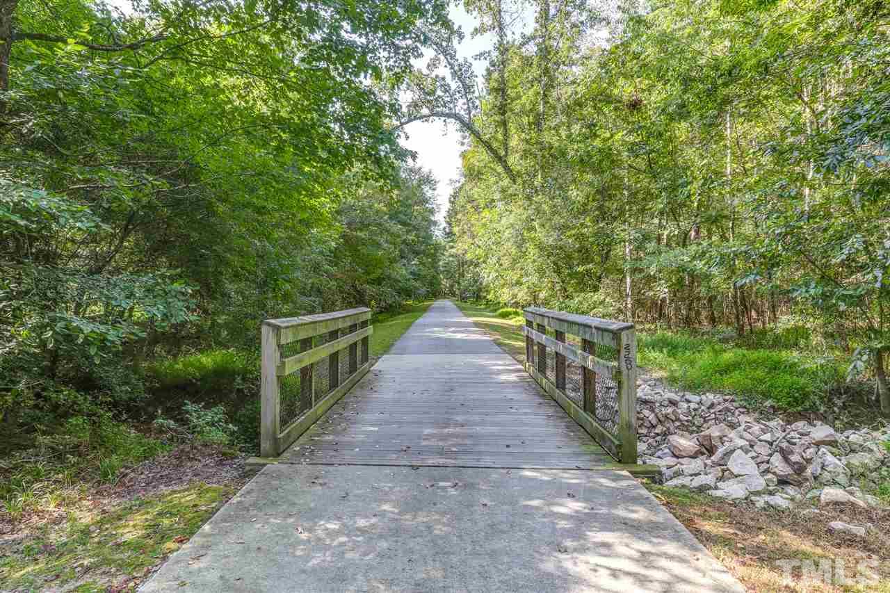 4143 White Kestrel Drive Raleigh, NC 27616 - Photo 30 of 30 a view of a pathway with a wrought fence