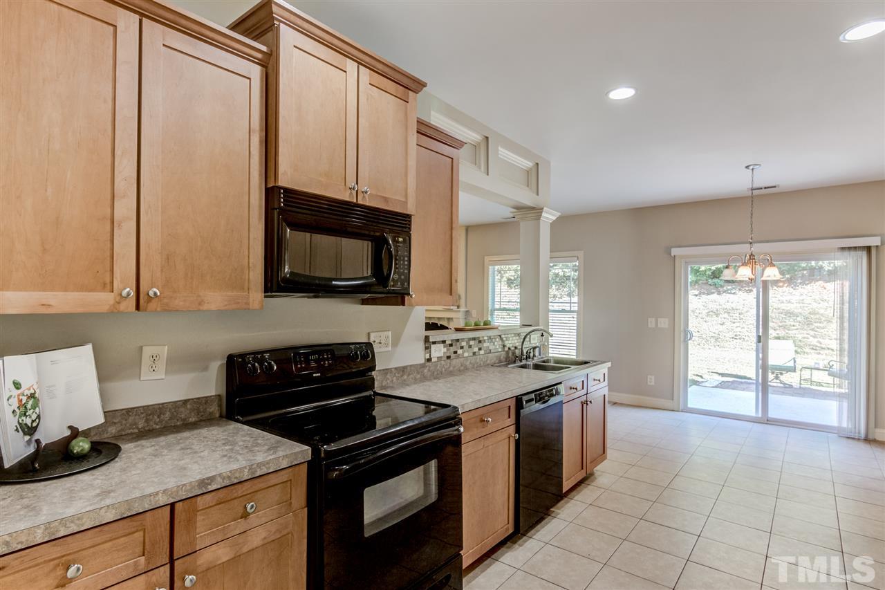 4143 White Kestrel Drive Raleigh, NC 27616 - Photo 5 of 30 a kitchen with stainless steel appliances granite countertop a stove a sink and a microwave