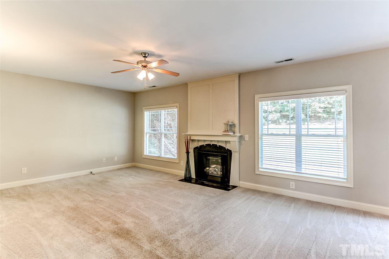 4143 White Kestrel Drive Raleigh, NC 27616 - Photo 8 of 30 a view of empty room with fireplace and fan
