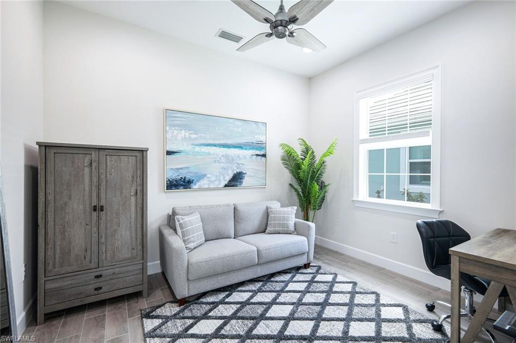 6875 Saona Court Naples, FL 34113 - Photo 13 of 21 a living room with furniture and a window