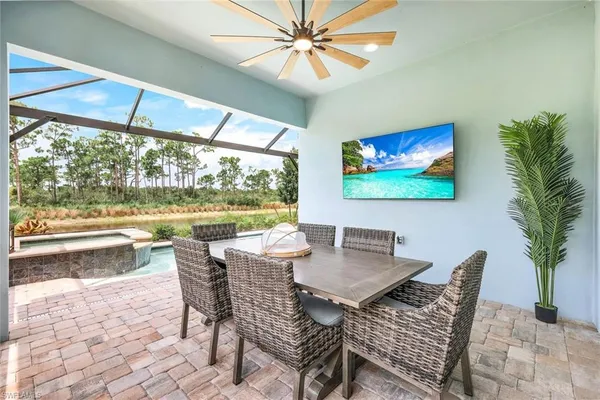 a dining room with furniture a large window and a rug