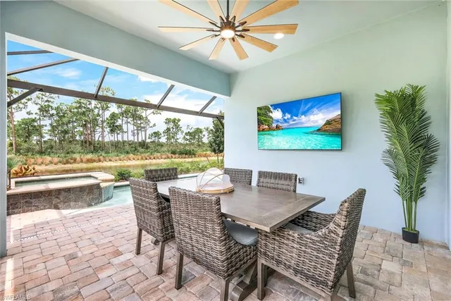 a dining room with furniture a large window and a rug