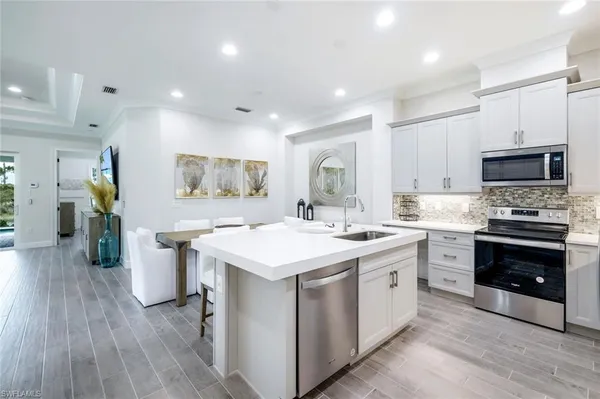 a kitchen with a sink stove and refrigerator