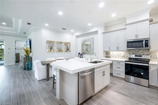 a kitchen with a sink stove and refrigerator
