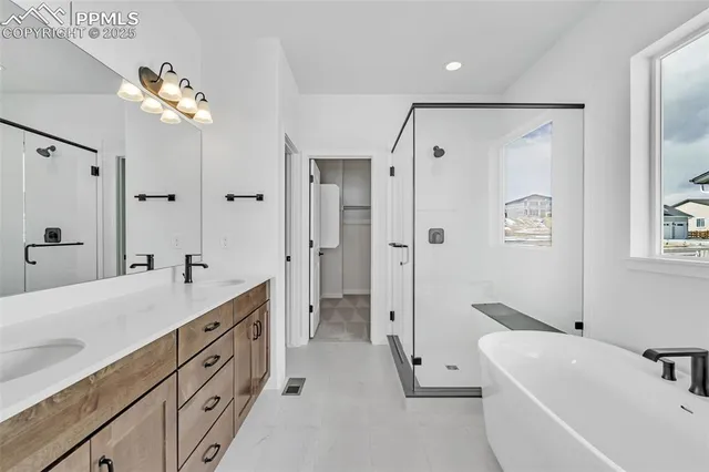 a bathroom with a double vanity sink mirror and chandelier