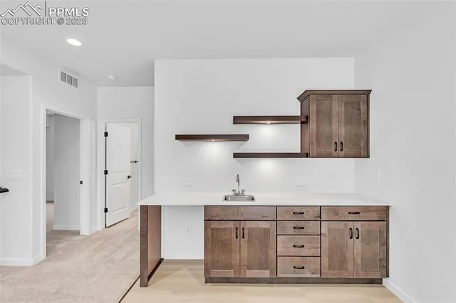a view of an empty room with a kitchen