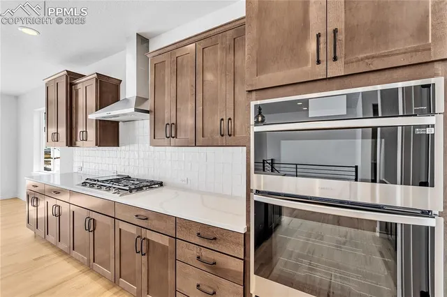a kitchen with stainless steel appliances granite countertop a stove and a refrigerator