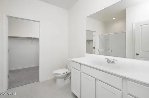 a kitchen with stainless steel appliances granite countertop a refrigerator a stove a sink a microwave and white cabinets