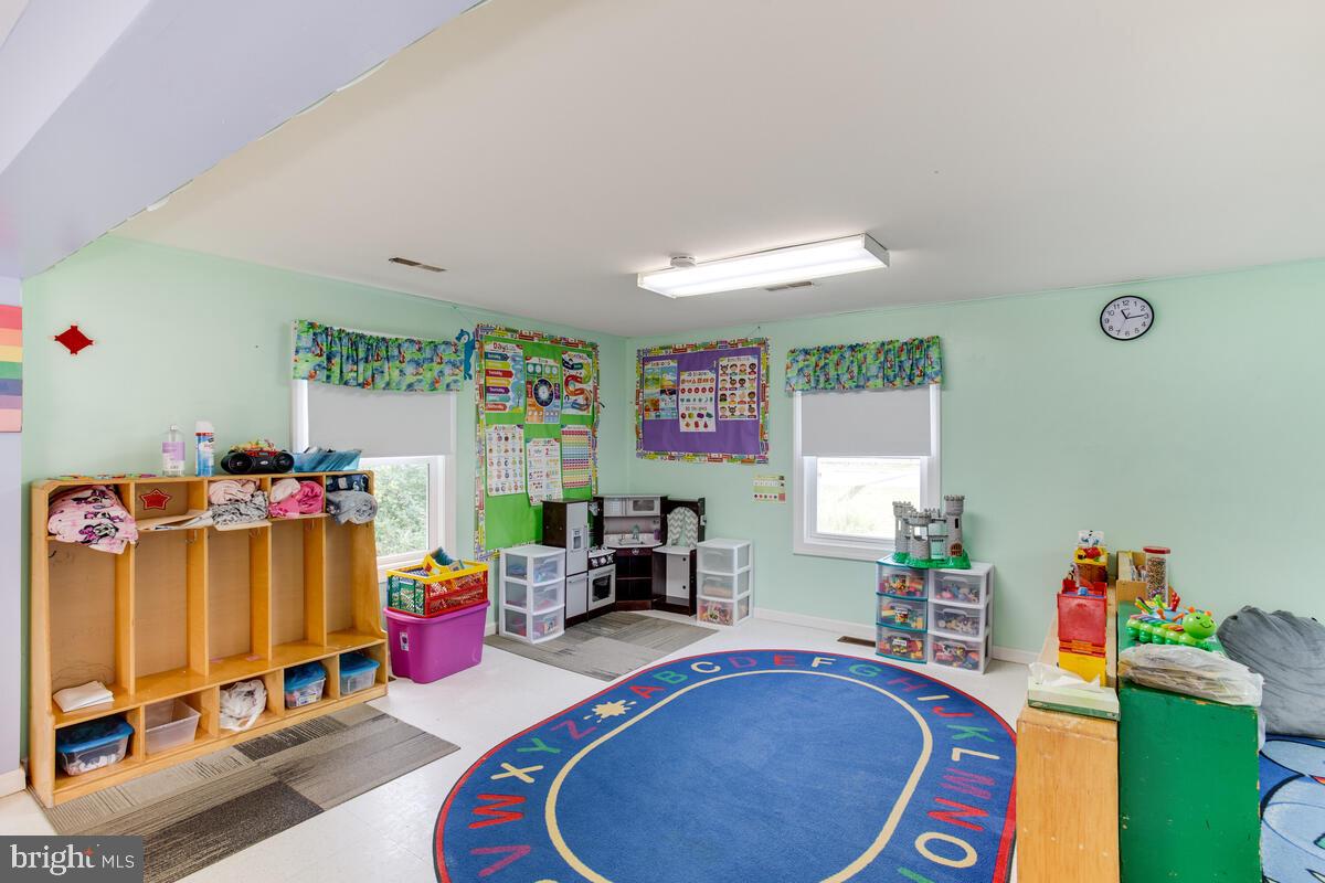 4425 Solomons Island Road Huntingtown, MD 20639 - Photo 9 of 65 a room with furniture a rug toys and a window