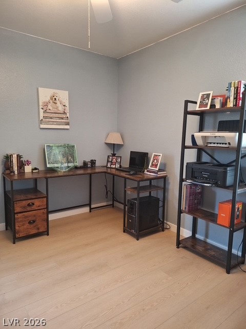 5171 Piazza Cavour Drive Las Vegas, NV 89156 - Photo 5 of 13 An inviting corner office space features light wood-look flooring, offering a productive work environment.