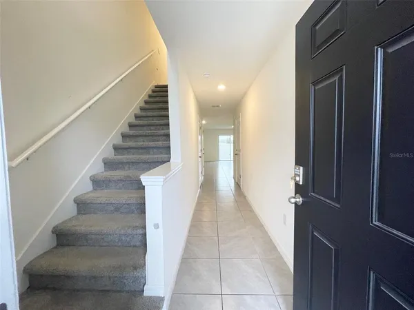 a view of entryway and hall with wooden floor