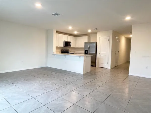a kitchen with stainless steel appliances a refrigerator sink and microwave