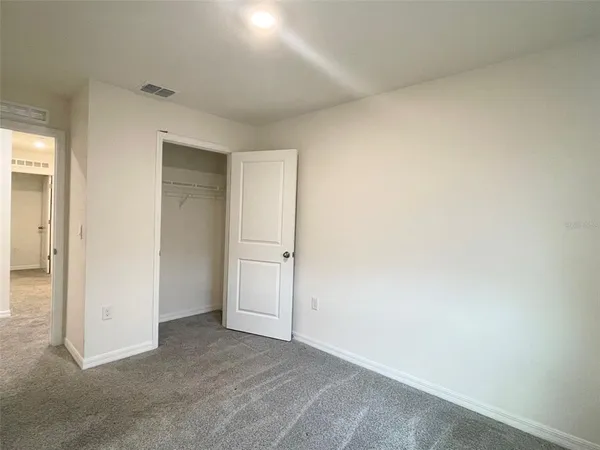 an empty room with closet area