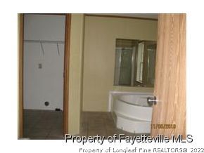 4990 Alamac Road Lumberton, NC 28358 - Photo 12 of 16 a bathroom with a sink and a mirror