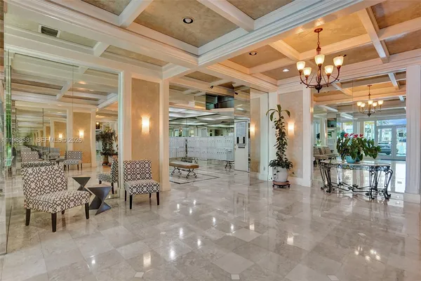 a view of a lobby with furniture and chandelier