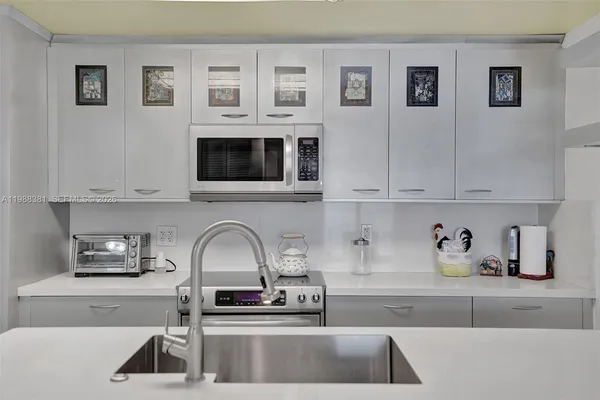 a kitchen with sink and cabinets
