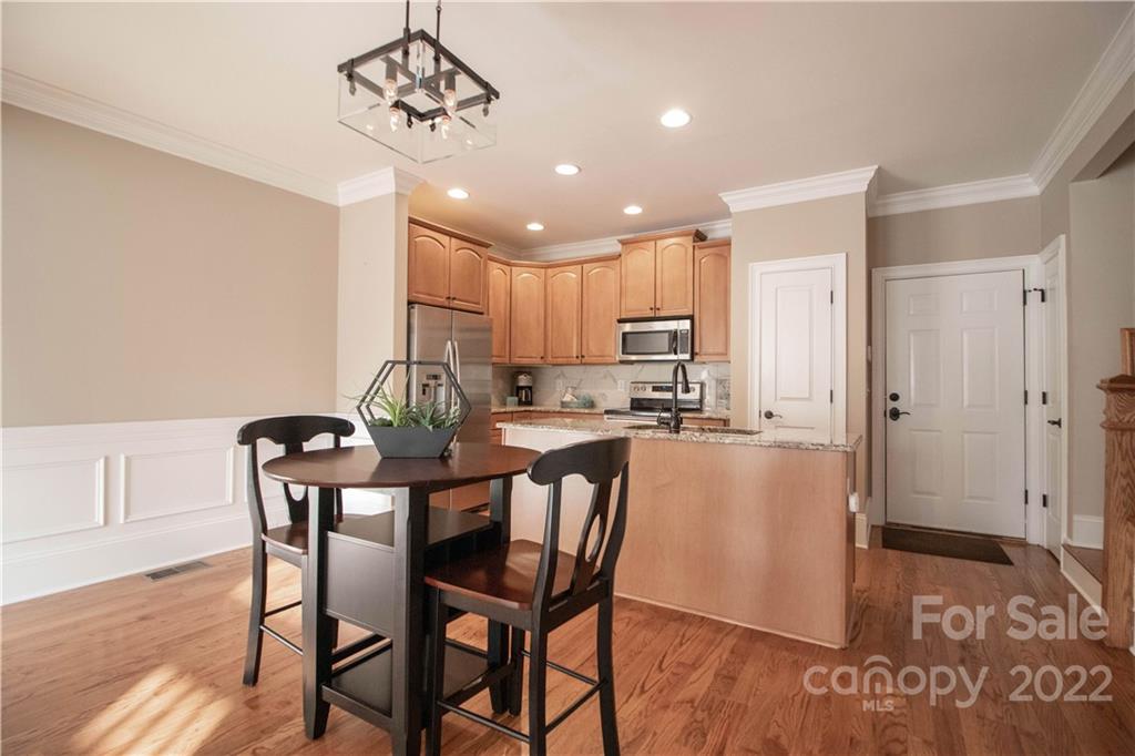 333 Spring Street Davidson, NC 28036 - Photo 12 of 44 a view of a dining room with furniture and wooden floor