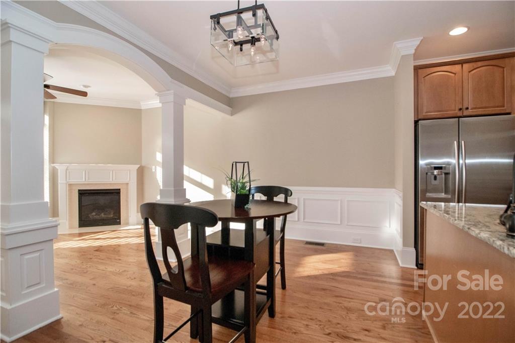 333 Spring Street Davidson, NC 28036 - Photo 13 of 44 a view of a dining room with furniture and wooden floor