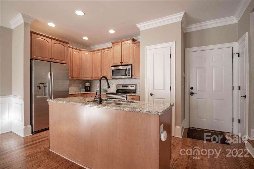 333 Spring Street Davidson, NC 28036 - Photo 14 of 44 a kitchen with kitchen island a counter top space a sink stainless steel appliances and cabinets