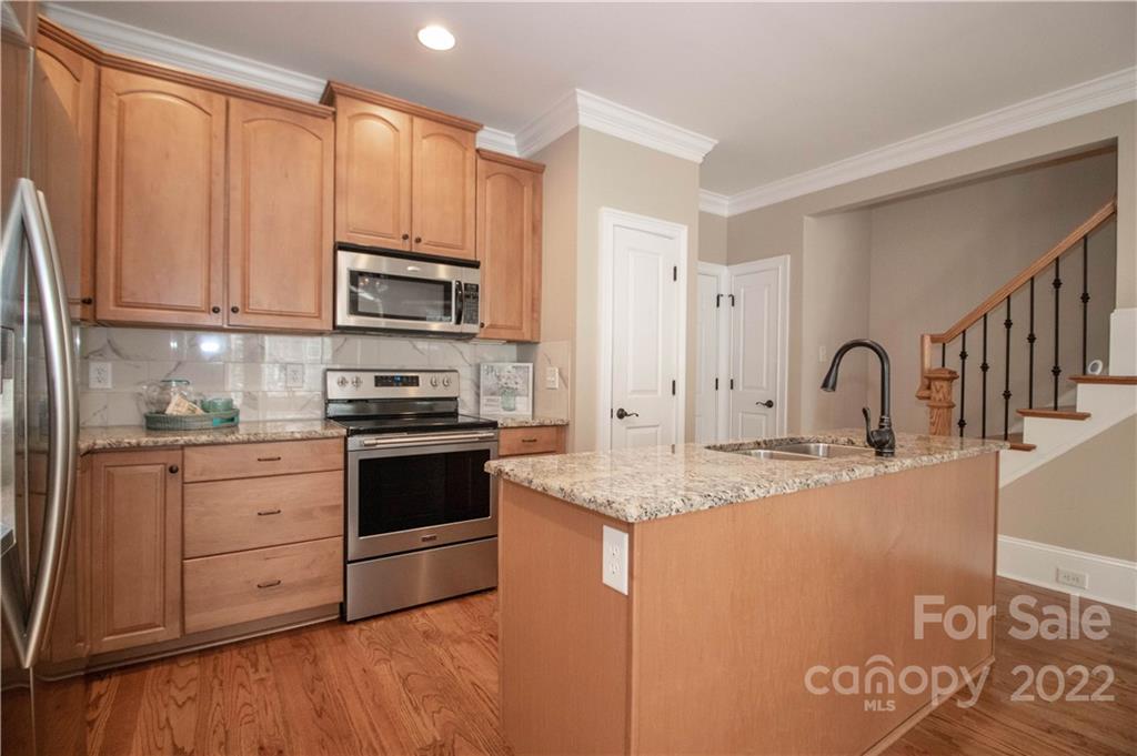 333 Spring Street Davidson, NC 28036 - Photo 15 of 44 a kitchen with stainless steel appliances granite countertop a stove a sink and a refrigerator