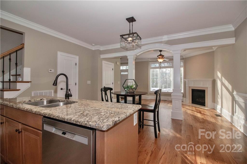 333 Spring Street Davidson, NC 28036 - Photo 18 of 44 a view of a dining room with furniture and a fireplace