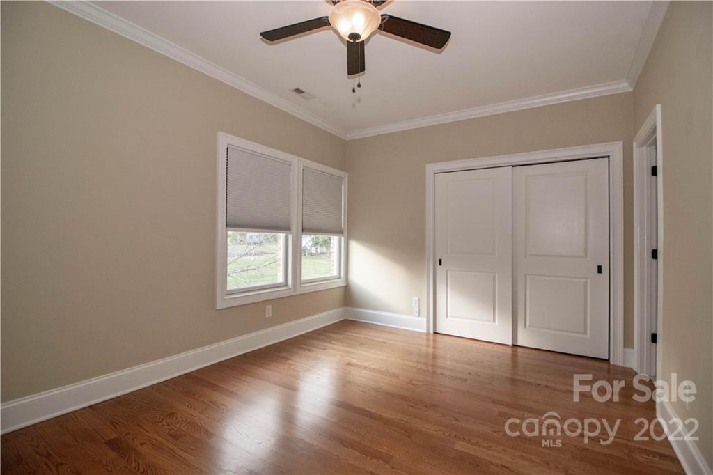 333 Spring Street Davidson, NC 28036 - Photo 21 of 44 a view of an empty room with wooden floor and a window