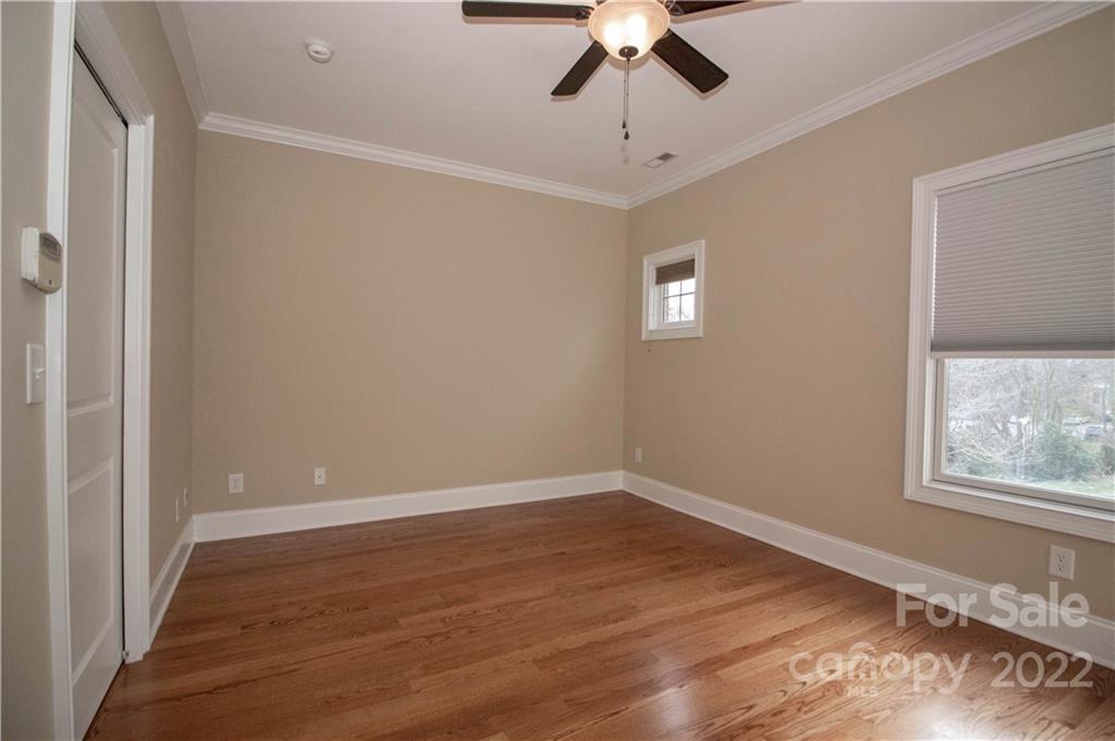 333 Spring Street Davidson, NC 28036 - Photo 24 of 44 a view of an empty room with wooden floor and a window