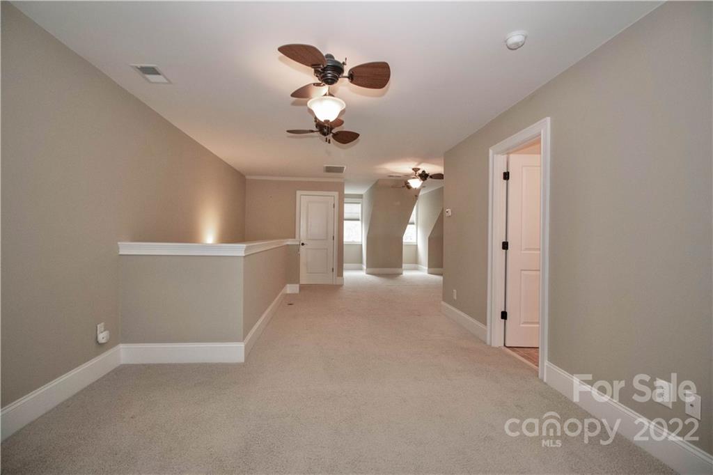 333 Spring Street Davidson, NC 28036 - Photo 34 of 44 a view of a room with a hanging light and kitchen view