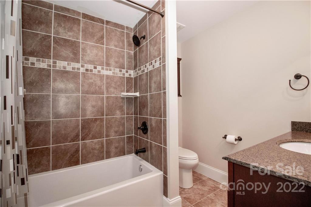 333 Spring Street Davidson, NC 28036 - Photo 37 of 44 a bathroom with a shower and a toilet