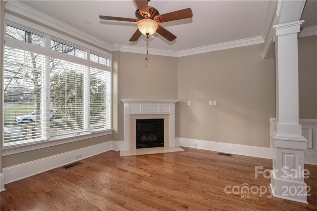333 Spring Street Davidson, NC 28036 - Photo 7 of 44 a view of an empty room with a window and a fireplace