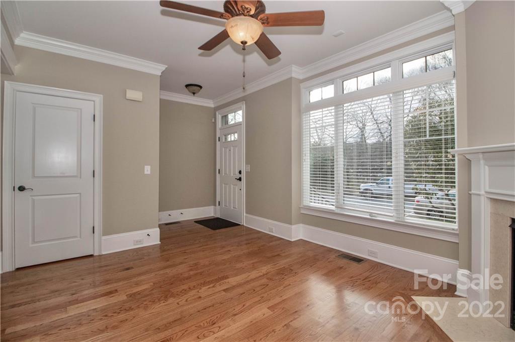 333 Spring Street Davidson, NC 28036 - Photo 8 of 44 a view of an empty room with a window and wooden floor