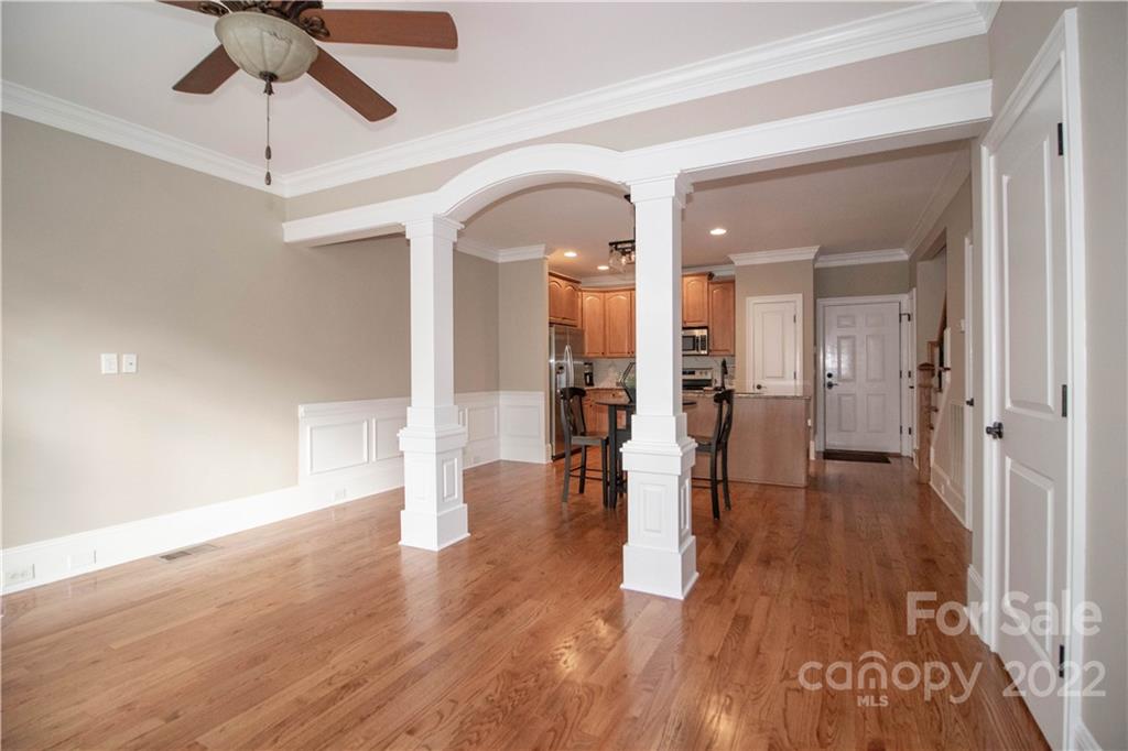 333 Spring Street Davidson, NC 28036 - Photo 9 of 44 a view of a hallway with wooden floor a chandelier fan