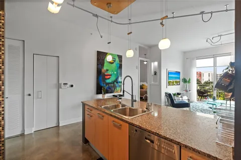 a dining room with kitchen island stainless steel appliances furniture a dining table and chairs