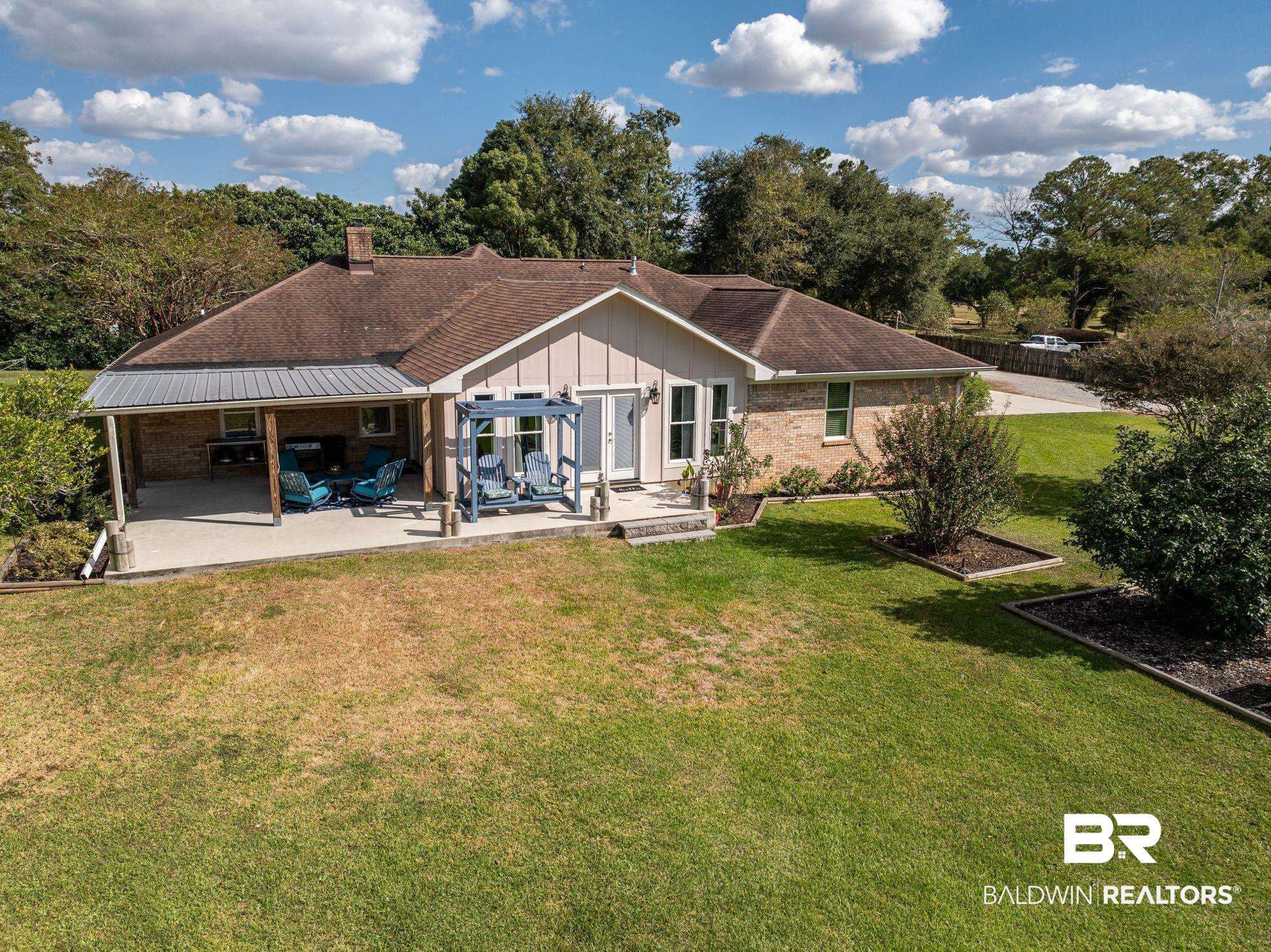 20037 County Road 33 Fairhope, AL 36532 - Photo 76 of 79 Back of property featuring a patio area and a lawn