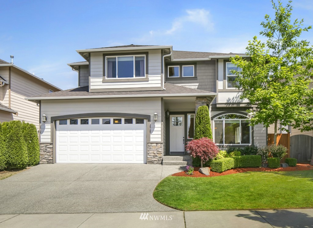 3815 222nd Place Southeast Bothell, WA 98021 - Photo 1 of 20 a front view of a house with a yard and garage
