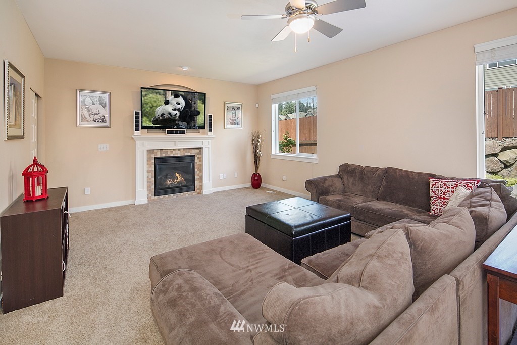 3815 222nd Place Southeast Bothell, WA 98021 - Photo 9 of 20 a living room with furniture a flat screen tv and a fireplace