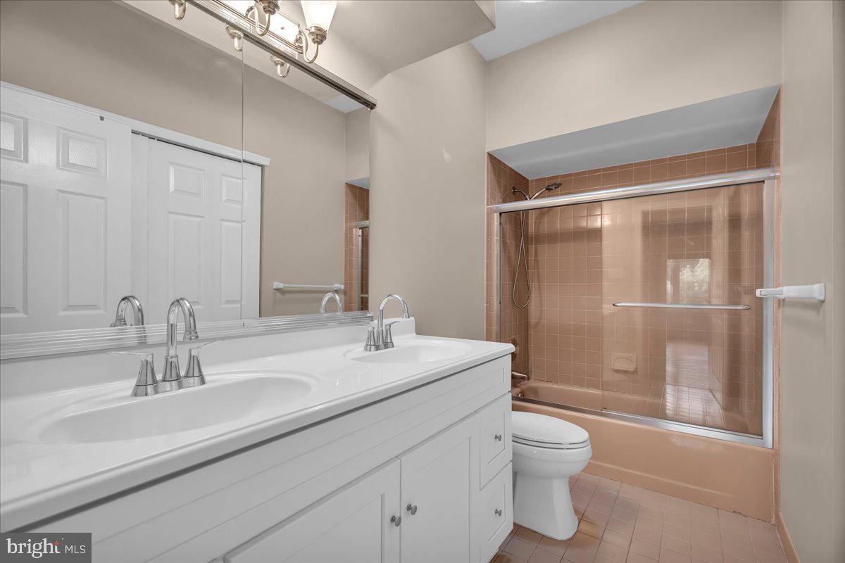 5 Promenade Place Voorhees, NJ 08043 - Photo 21 of 24 a bathroom with a toilet a sink and glass door