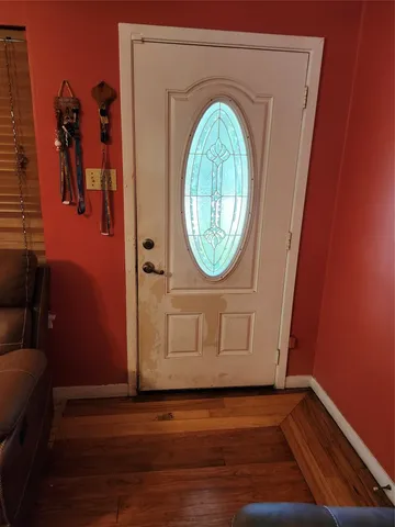 a view of a livingroom with wooden floor and a water heater