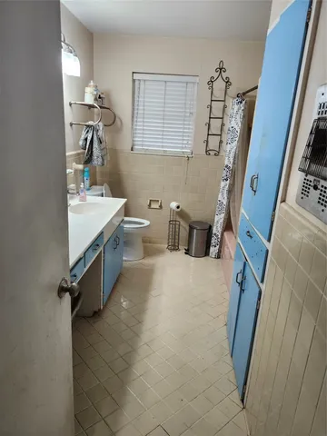 a bathroom with a sink a mirror and a toilet