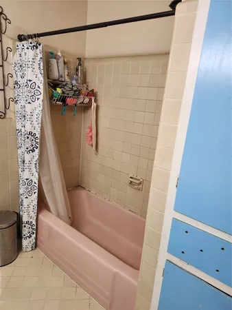 a bathroom with a bathtub and shower